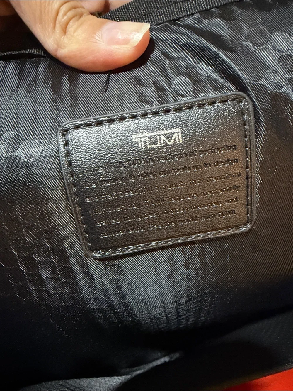 Tumi Red and Black Men/Women’s Backpack with Multiple Front Pockets